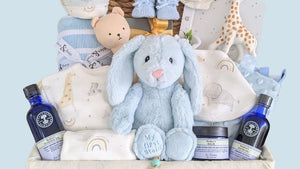 Baby boy gifts for a newborn in a hamper basket with blue presents.