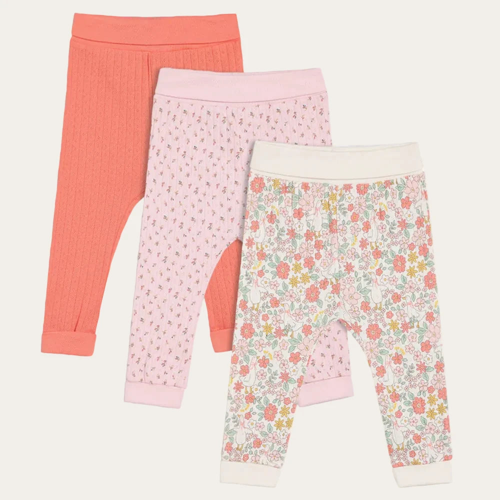 Baby girl leggings in coral, pink floral, and white floral ditsy prints.