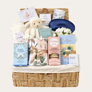 Mum to be gifts hamper presented in a large wicker basket with white lamb coft toy and sweet treats for mum to be from Bumbles and Boo.