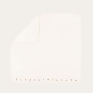 Cream organic baby blanket with bunny embroidery detail around edge.