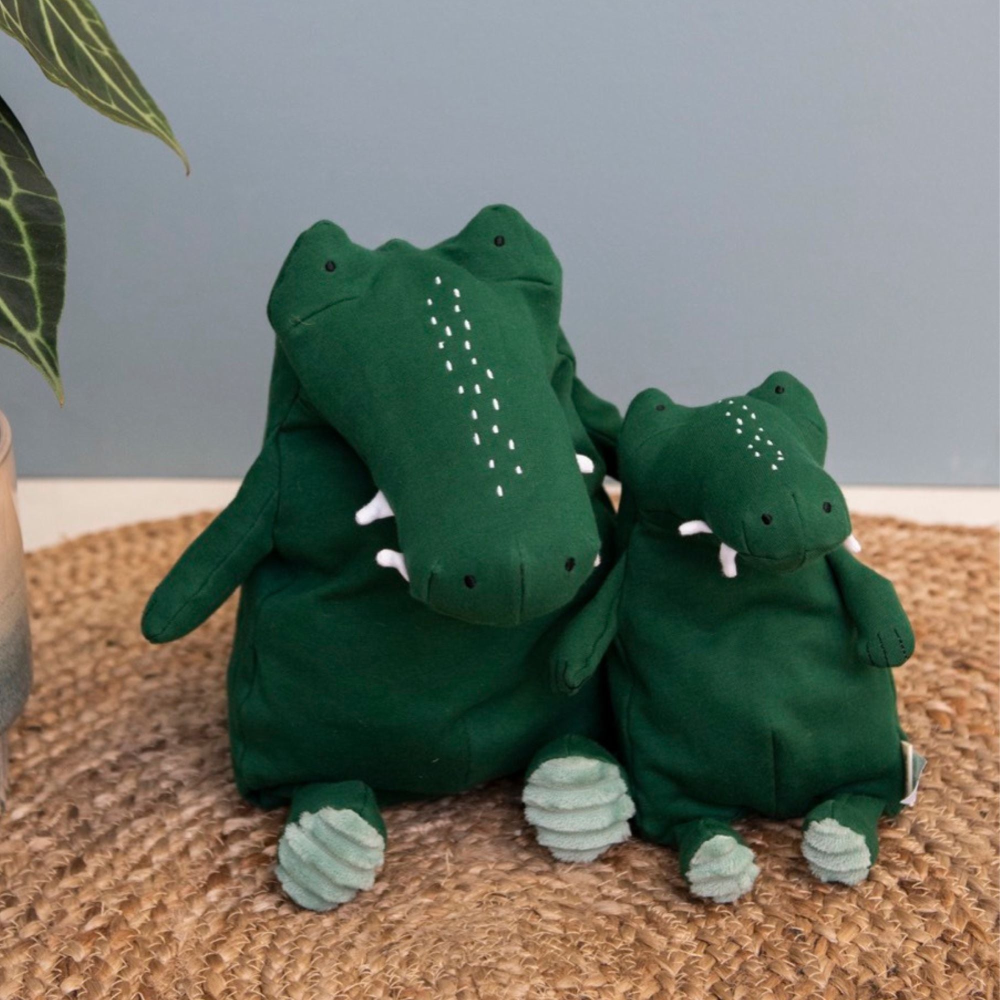 Organic and eco friendly squishy and goofy small green crocodile soft toy from Trixie shown with the larger plush crocodile toy. Suitable from birth.