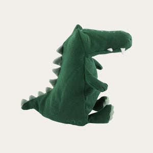 Organic cotton and eco friendly squishy and goofy green crocodile soft toy from Trixie shown from side view with his spikes and tail on display. Suitable from birth.
