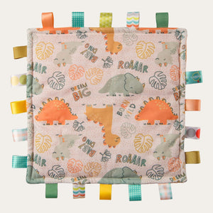 Bright and cheerful dinosaur print soft taggies baby comfort blanket from Mary Meyer in oranges and greens.