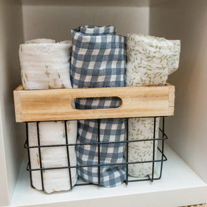 White muslin swaddle wrap with small shoaling fish print