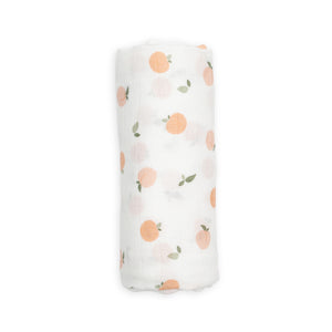 Soft white bamboo swaddle with cute peach design. Unisex muslin for baby.