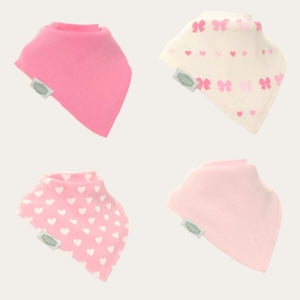 Four pack of baby bandana ziggle bibs with pink and white heart and bow patterns.