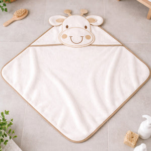 White giraffe hooded newborn baby towel laid flat on bathroom floor