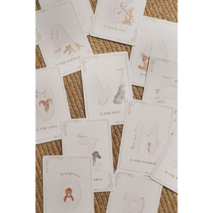 Assorted alphabet cards on a woven background, including wolf, zebra, meerkat and orangutan.