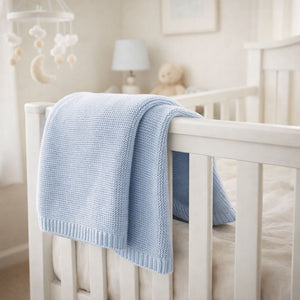 A blue knit baby blanket which is organic knit perfect for baby essentials