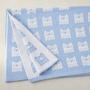 close up of owl print on blue baby blanket
