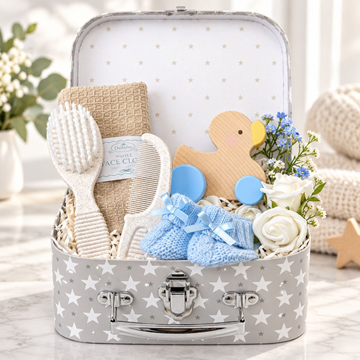 Newborn baby boy gifts in a hamper. Presents include eco friendly baby accessories. Bumbles and Boo.