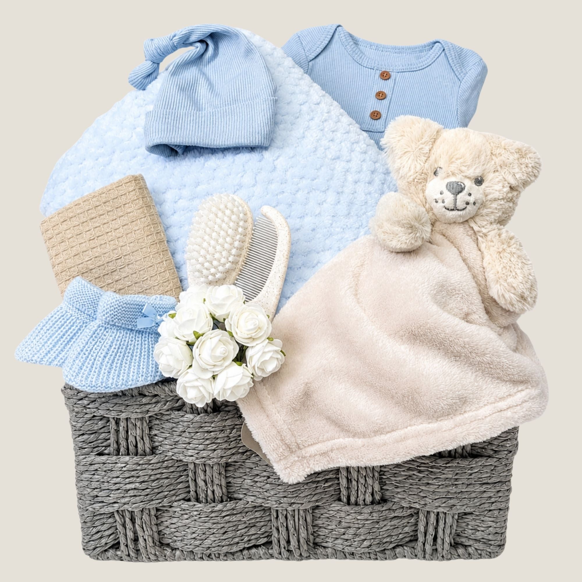 Newborn Baby boy gifts basket with blanket and blue clothes. Hamper by Bumbles and Boo.