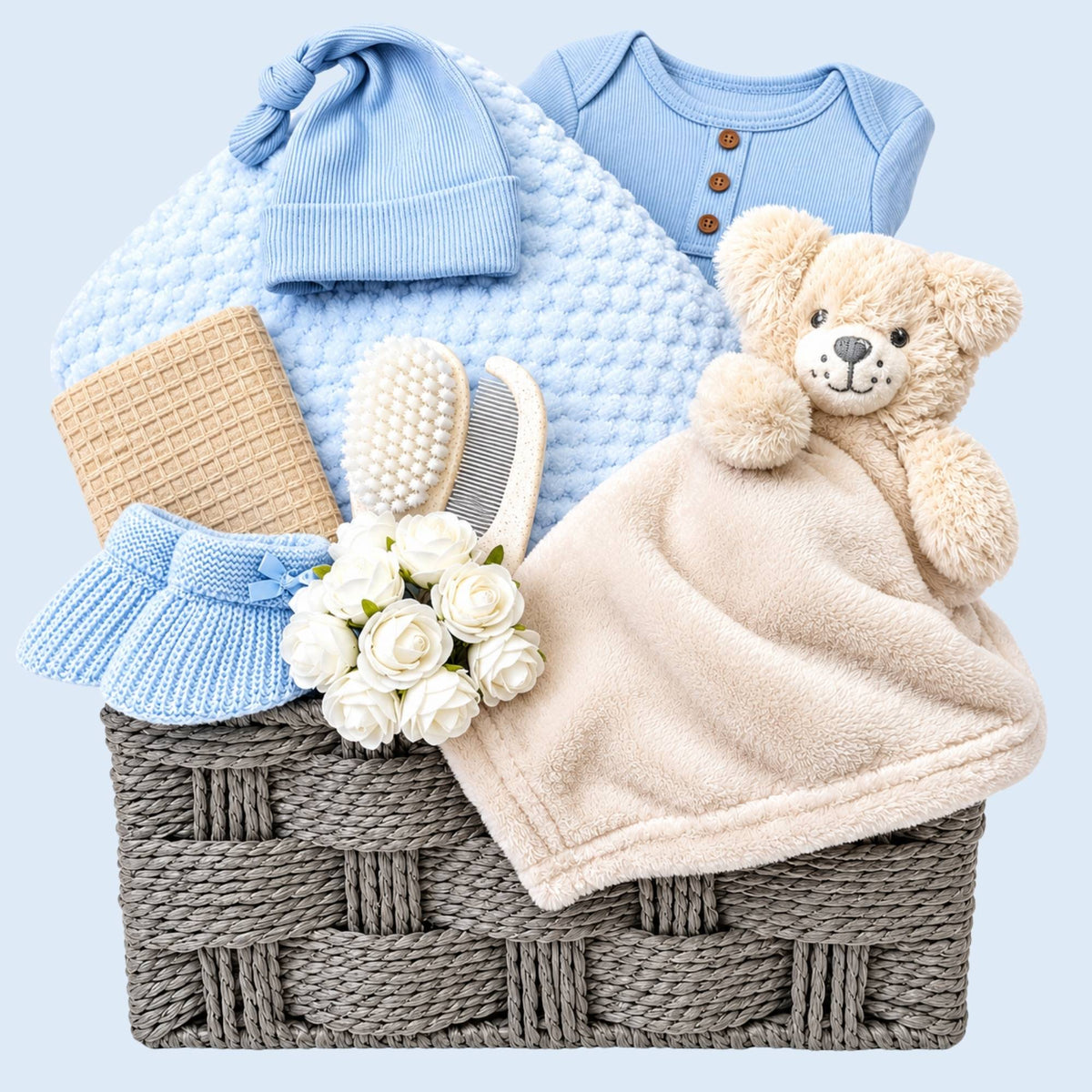 Newborn Baby boy gifts basket with blanket and blue clothes. Hamper by Bumbles and Boo.