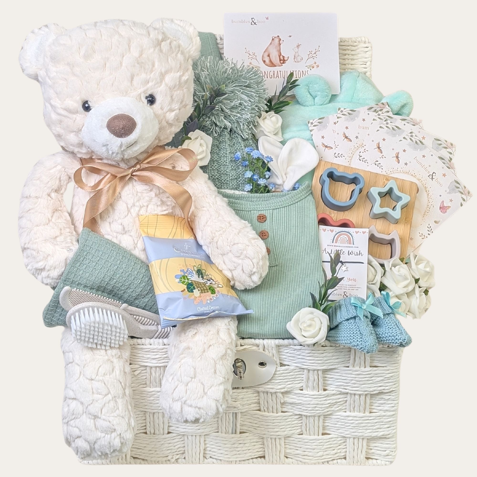 Baby boy gifts hamper basket with a large cuddly teddy bear and mint green clothing. Bumbles and Boo.