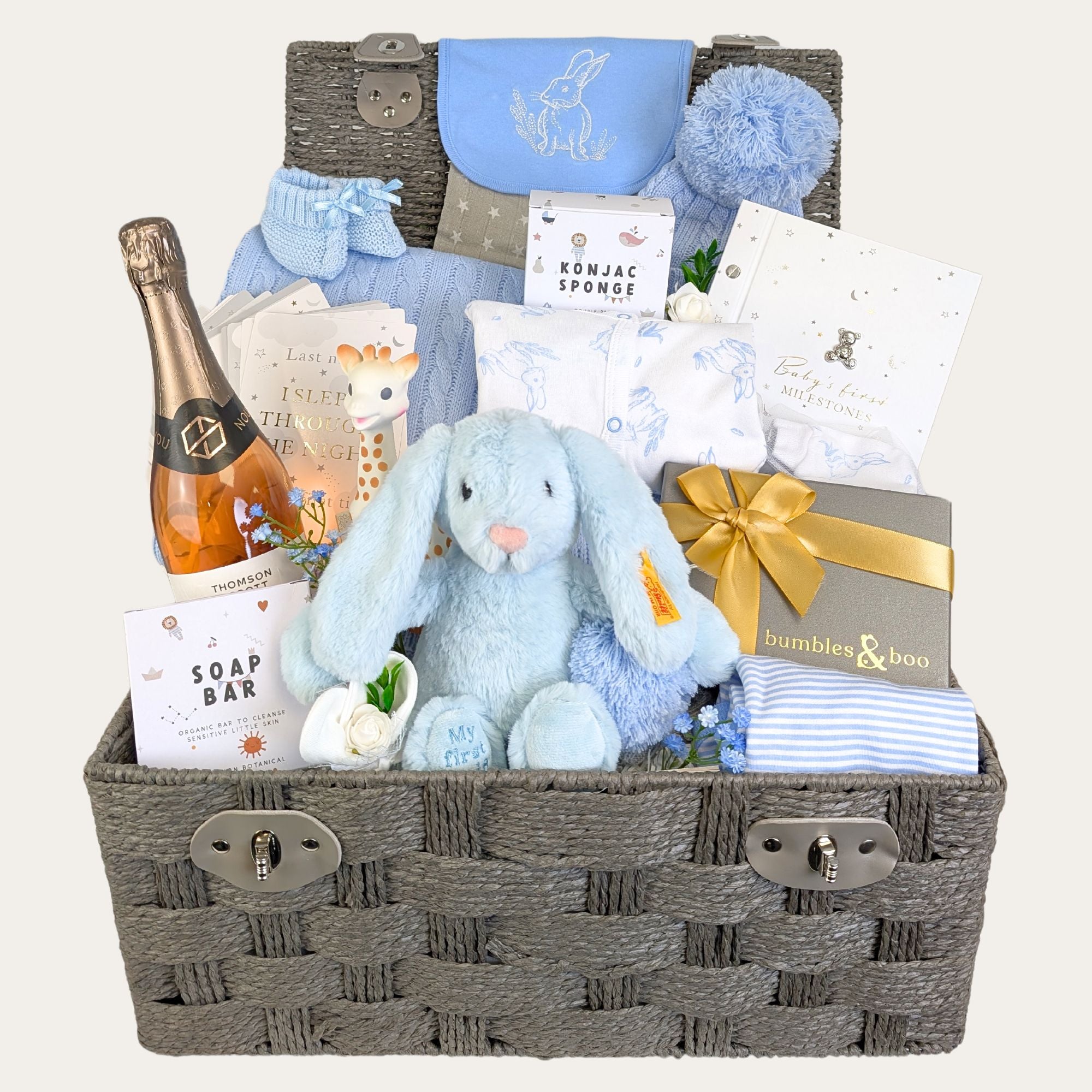 Baby boy gifts hamper filled with luxury presents. Includes blue clothes, bunny toy and treats for parents.
