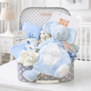 A gifts hamper for a baby boy with an elephant baby comforter and blue baby essentials