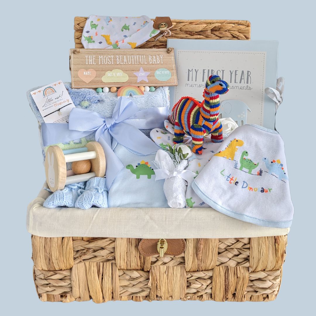 Beautiful basket for a new baby boy with cotton clothing set, organic dinosaur rattle toy, baby blanket, wooden toy, baby boy journal and a gift for a new mummy.