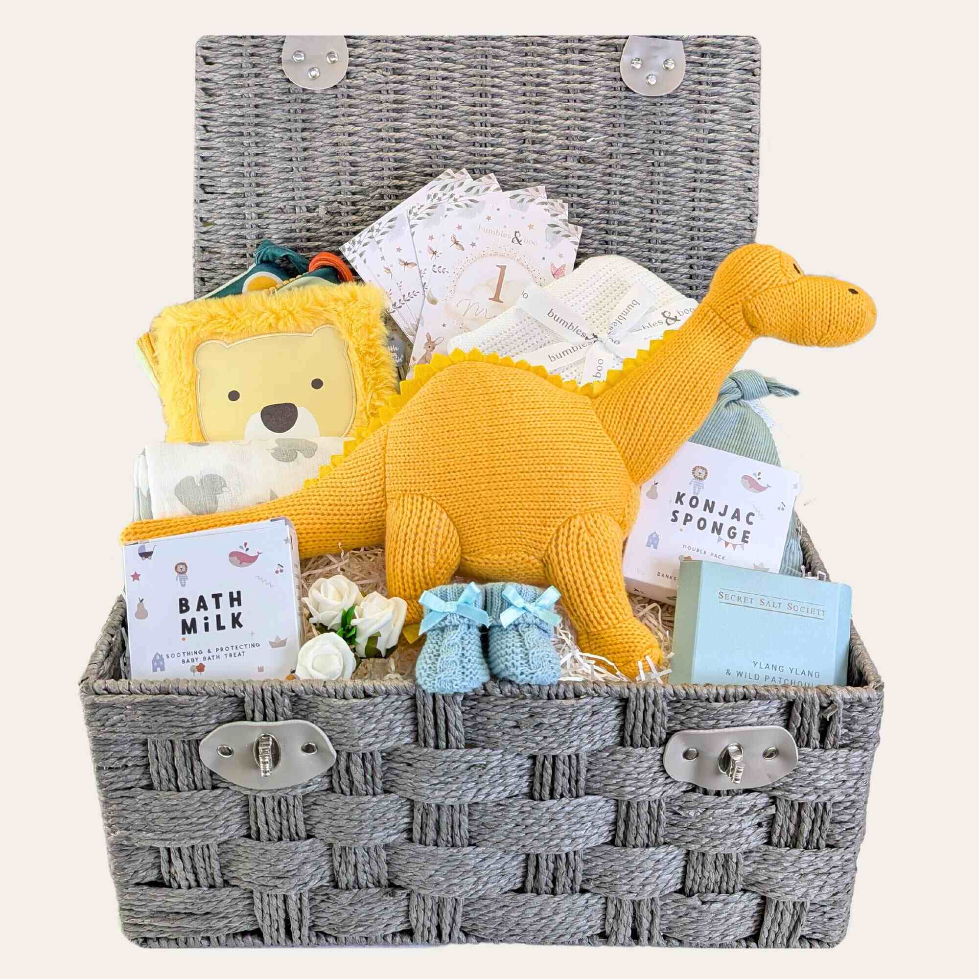 Large baby boy hamper with gifts including yellow organic knit dinosaur and blue baby booties. Bumbles and Boo.