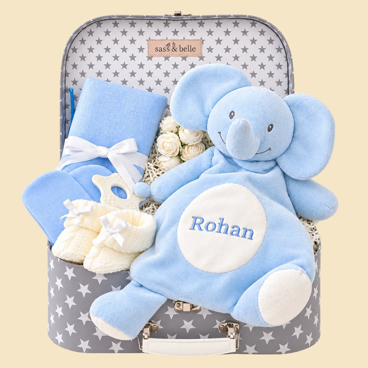 A gifts hamper for a baby boy with an elephant baby comforter and blue baby essentials