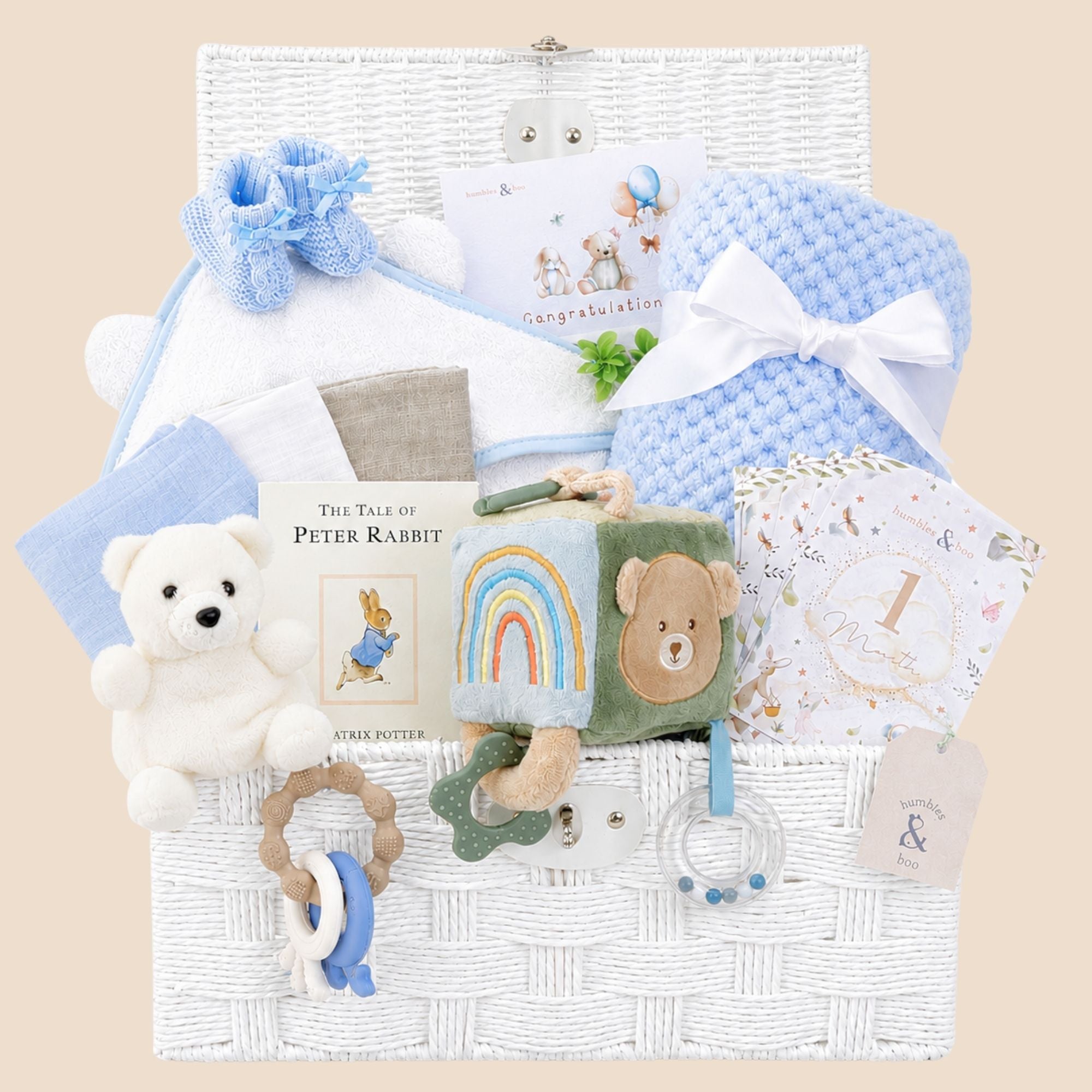 Baby boy hamper gift with toys and books in a white gifts hamper.