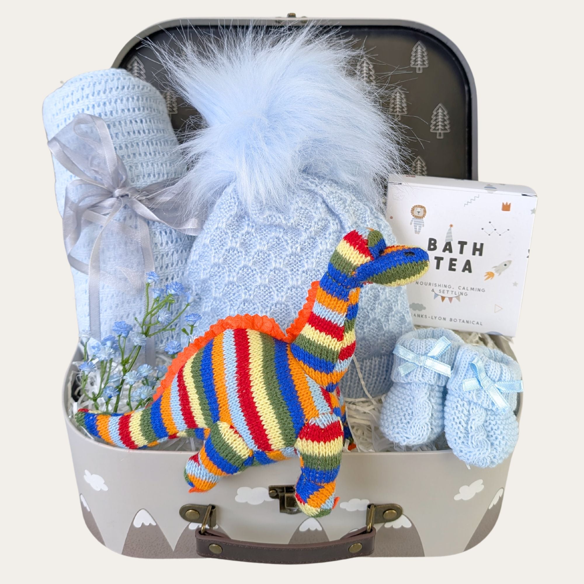 Baby boy gifts in a hamper with lid. Blue clothes and stripy dinosaur.Bumbles and Boo.