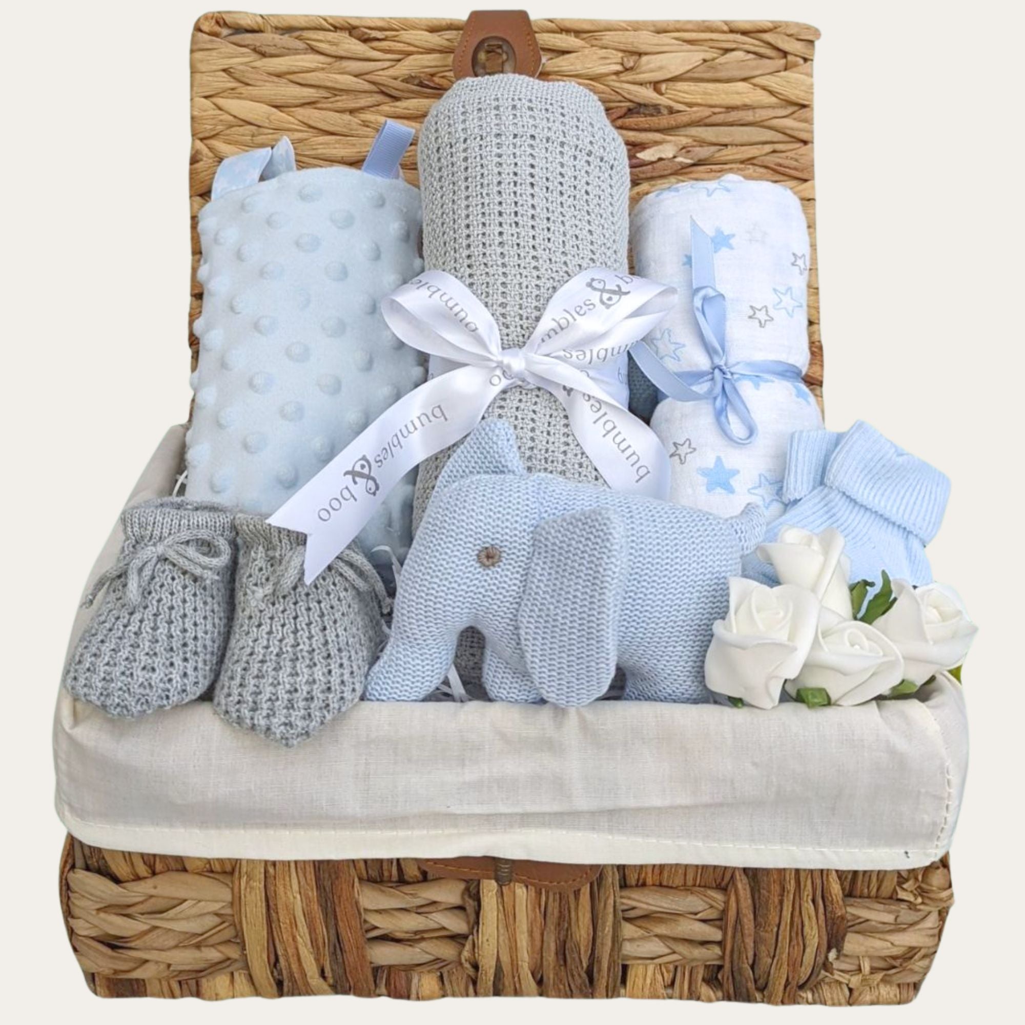 Gifts for a new baby boy in a hamper basket with grey and blue presents includes elephant rattle. Bumbles and Boo.