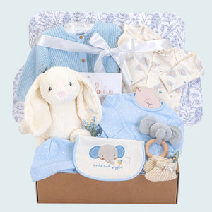 New baby boy gift hamper box with blue and white gifts. This hamper contains a bunny soft toy and blue elephant clothes set.