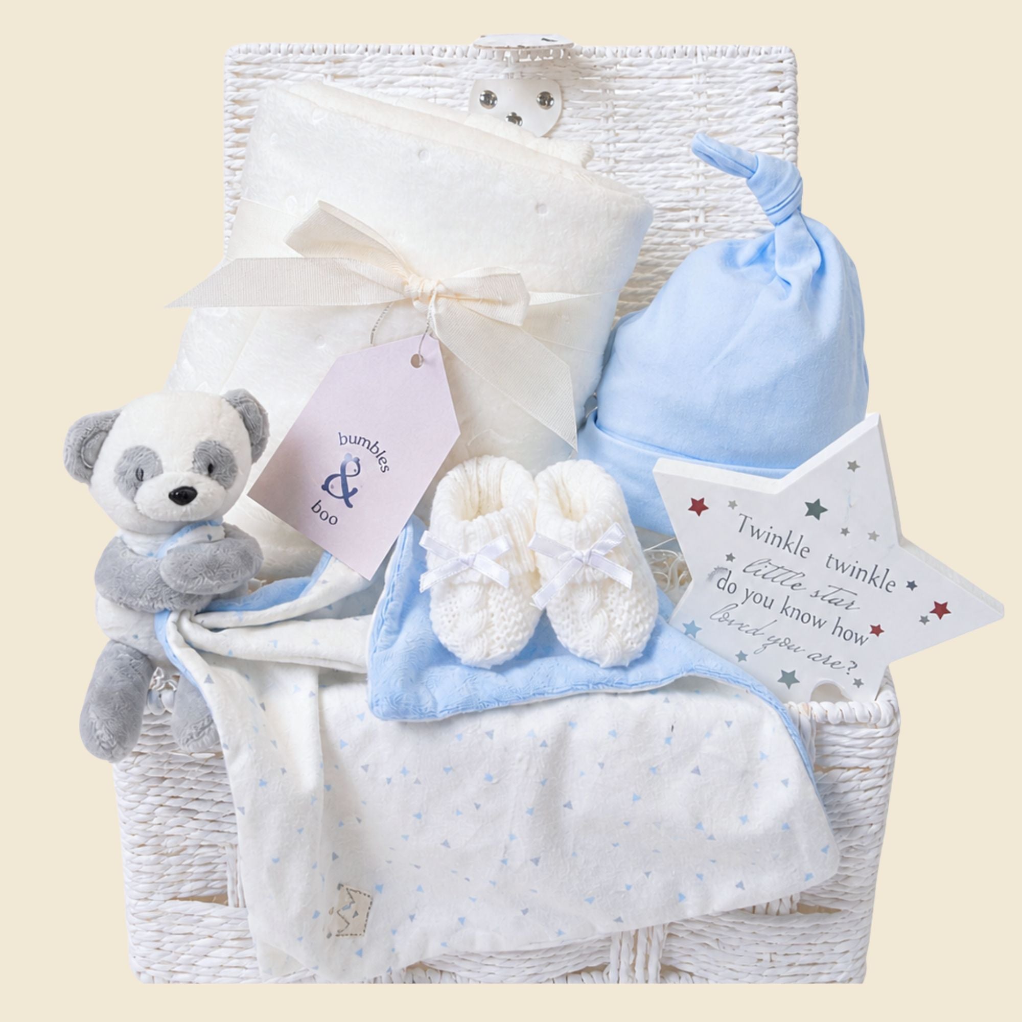 Unique baby boy gifts in a white hamper basket with blanket, blue hat and panda bear newborn comforter.