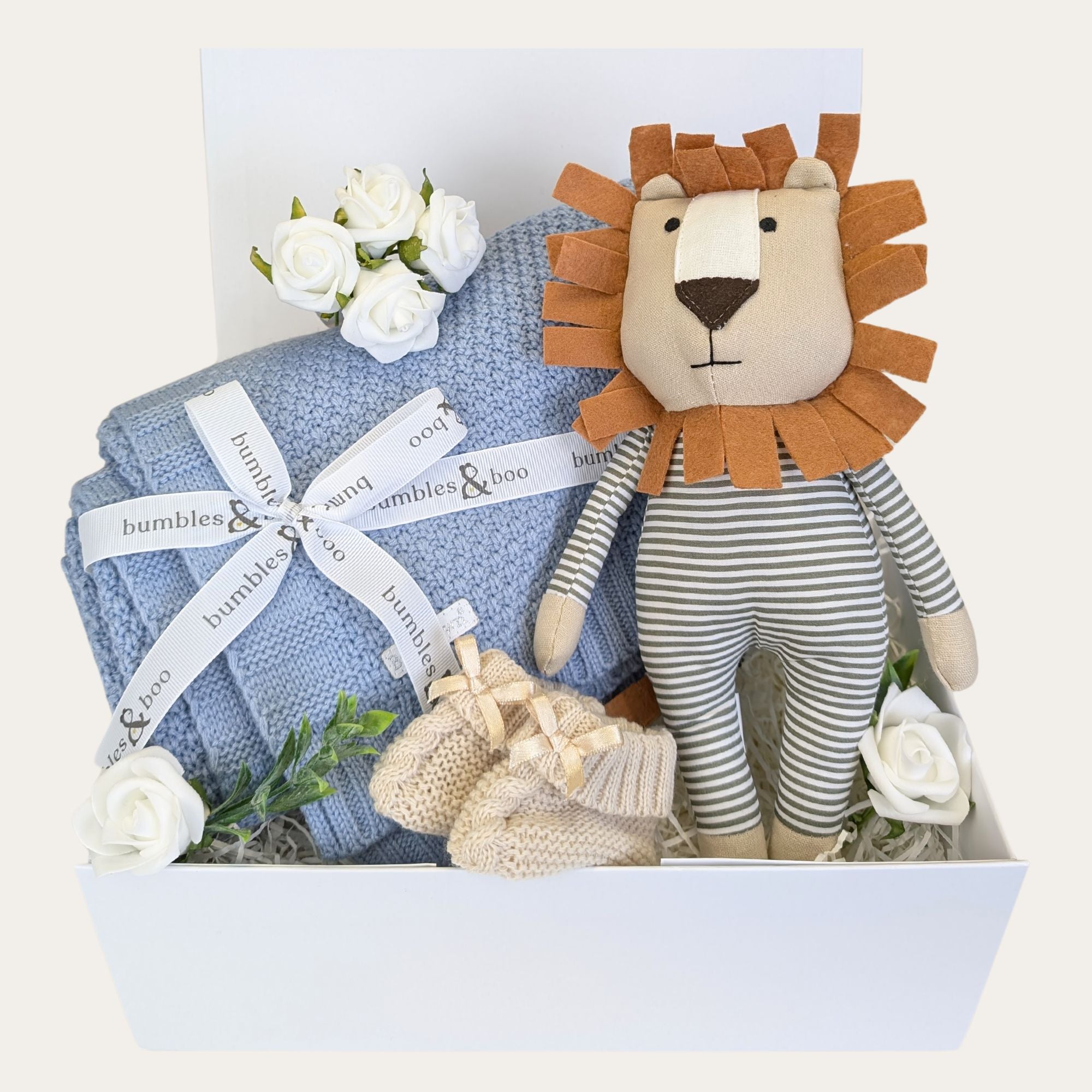 Baby boy hamper in a white gifts box with blue blanket and lion soft toy. Bumbles and Boo.