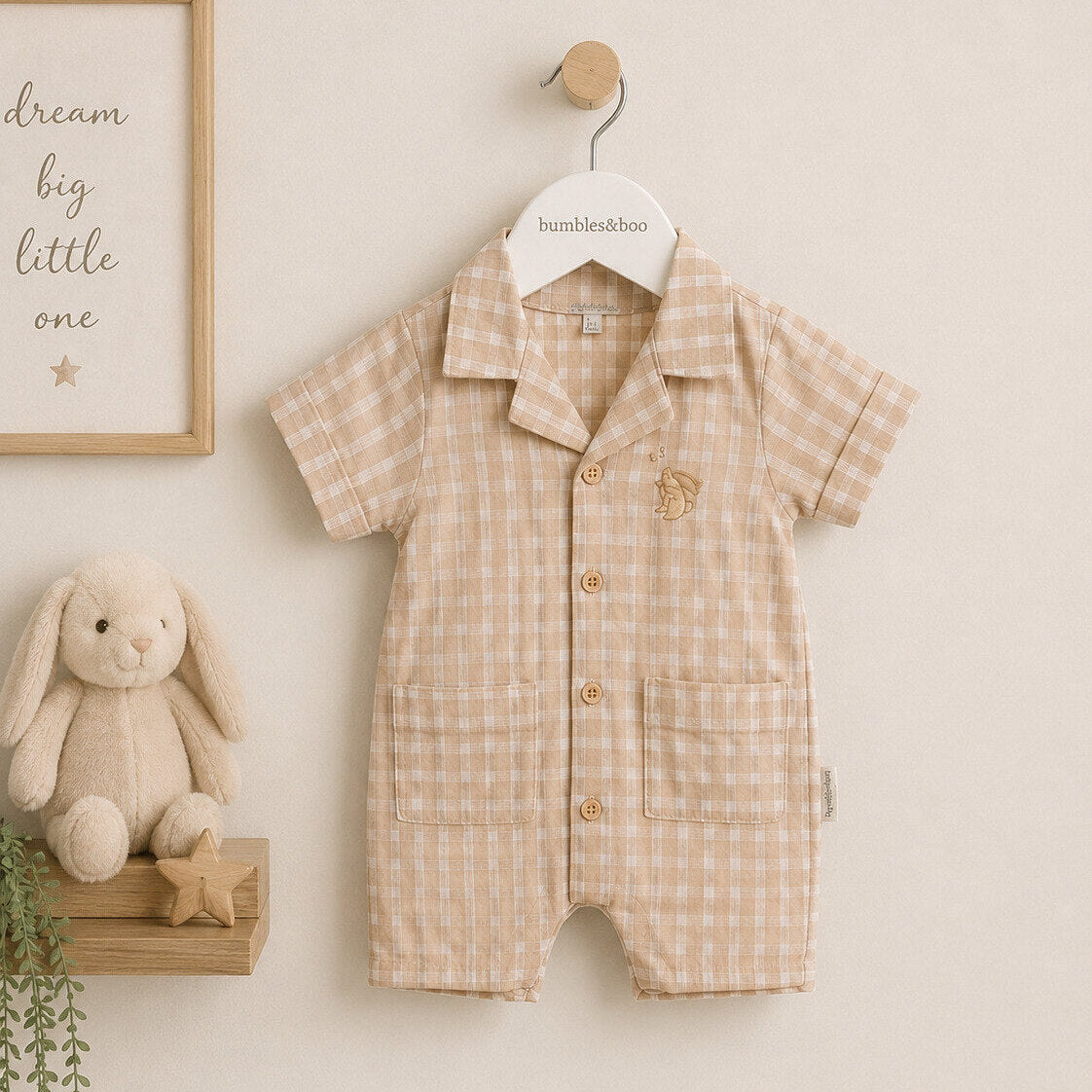 Baby boy romper suit, in lightweight cotton material with a brown chequered pattern. Short trousers and short sleeves