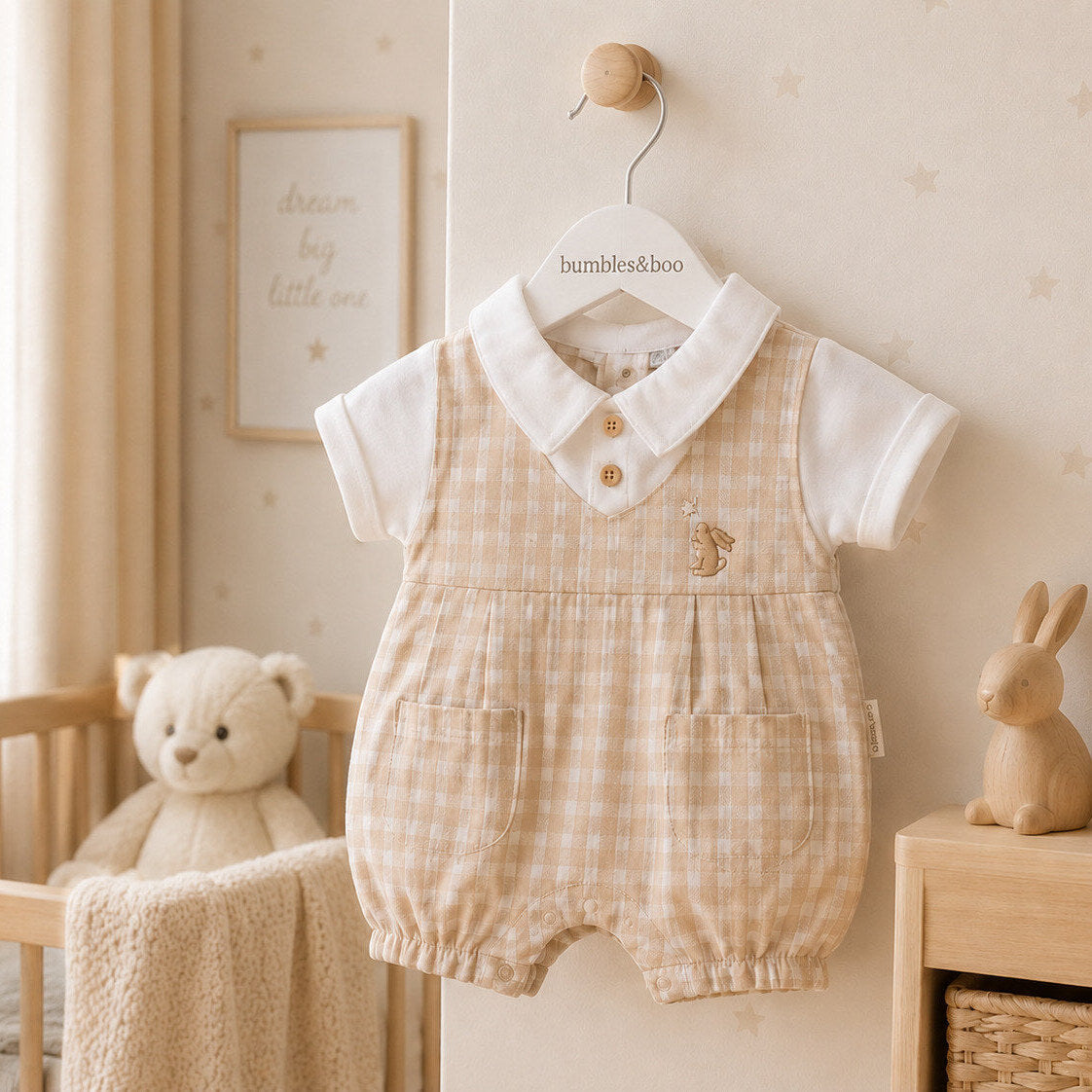 Baby boy chequered romper suit in beige with short sleeves and trousers. White collar and sleeves as a sewn in shirt.