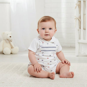 Baby boy wearing white vehicle print dungaree set with short sleeve top, soft cotton blend baby clothes for everyday wear