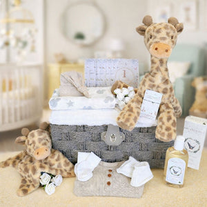 Baby gift basket with plush giraffes, baby towel, clothing and baby skincare.