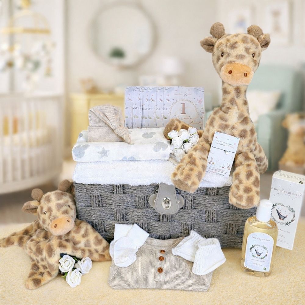 Baby gift basket with plush giraffes, baby towel, clothing and baby skincare.