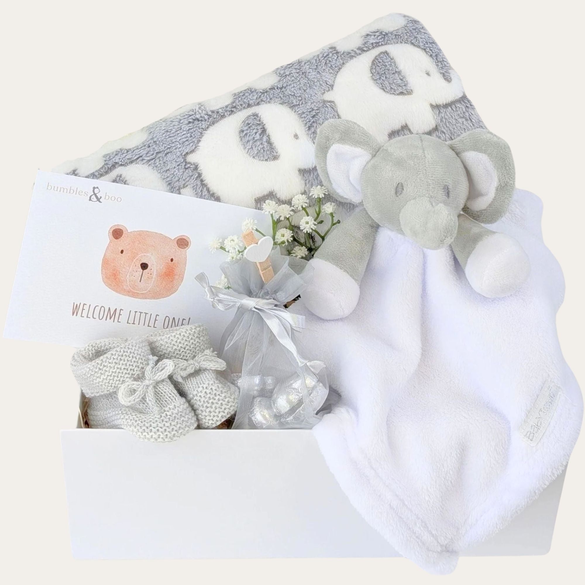 White new baby gifts box by Bumbles and Boo. Hamper includes a grey elephant pattern blanket & personalised baby comforter.