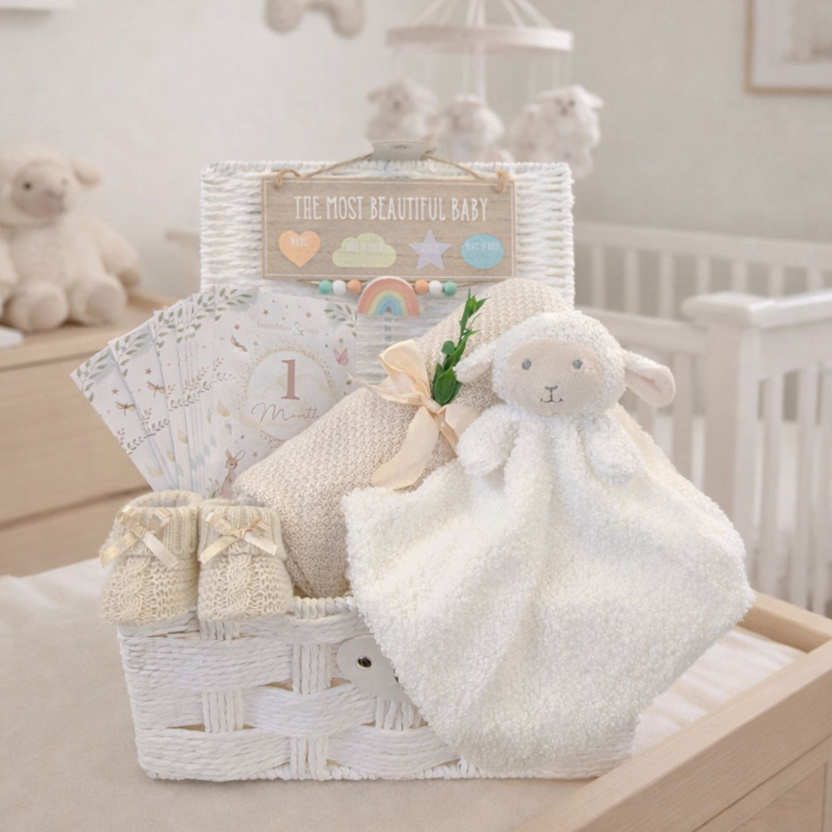Baby gifts hamper basket with a lamb and bamboo knit baby blanket.