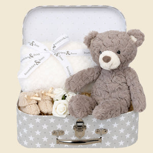 Baby gifts hamper with presents including bear and white blanket in a grey stars luggage case by Bumbles and Boo.