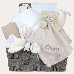 Baby gifts basket with personalised presents to welcome a new baby in cream and beige. Hamper by Bumbles and Boo.