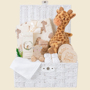 Baby hamper gifts for a newborn with giraffe soft toy and skincare in a hamper basket.