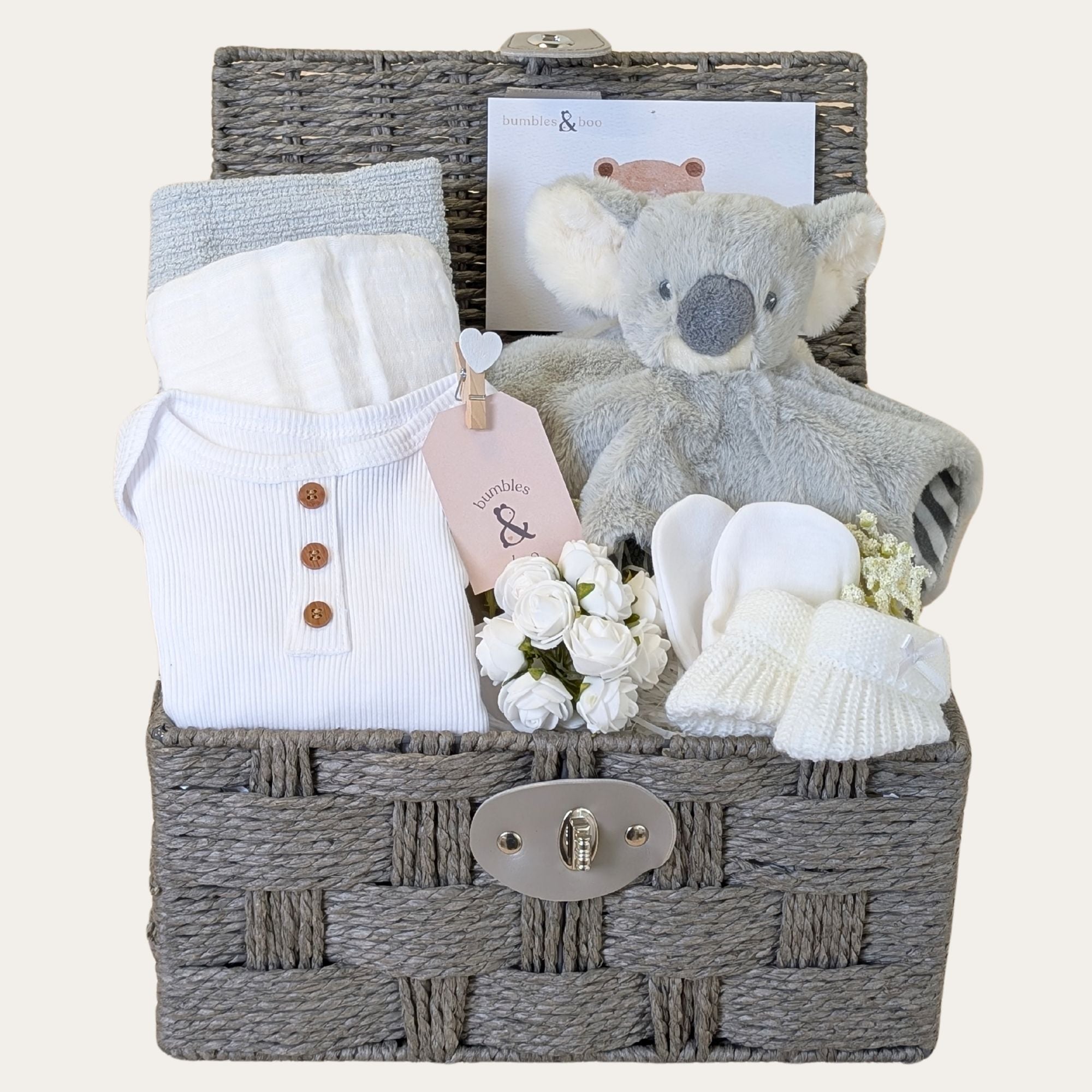 New baby gifts basket with white and grey presents. This baby hamper includes soft koala comforter toy and baby essentials. Bumbles and Boo.