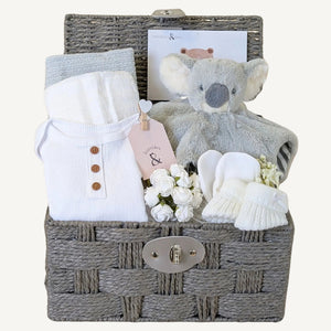 New baby gifts basket with white and grey presents. This baby hamper includes soft koala comforter toy and baby essentials. Bumbles and Boo.