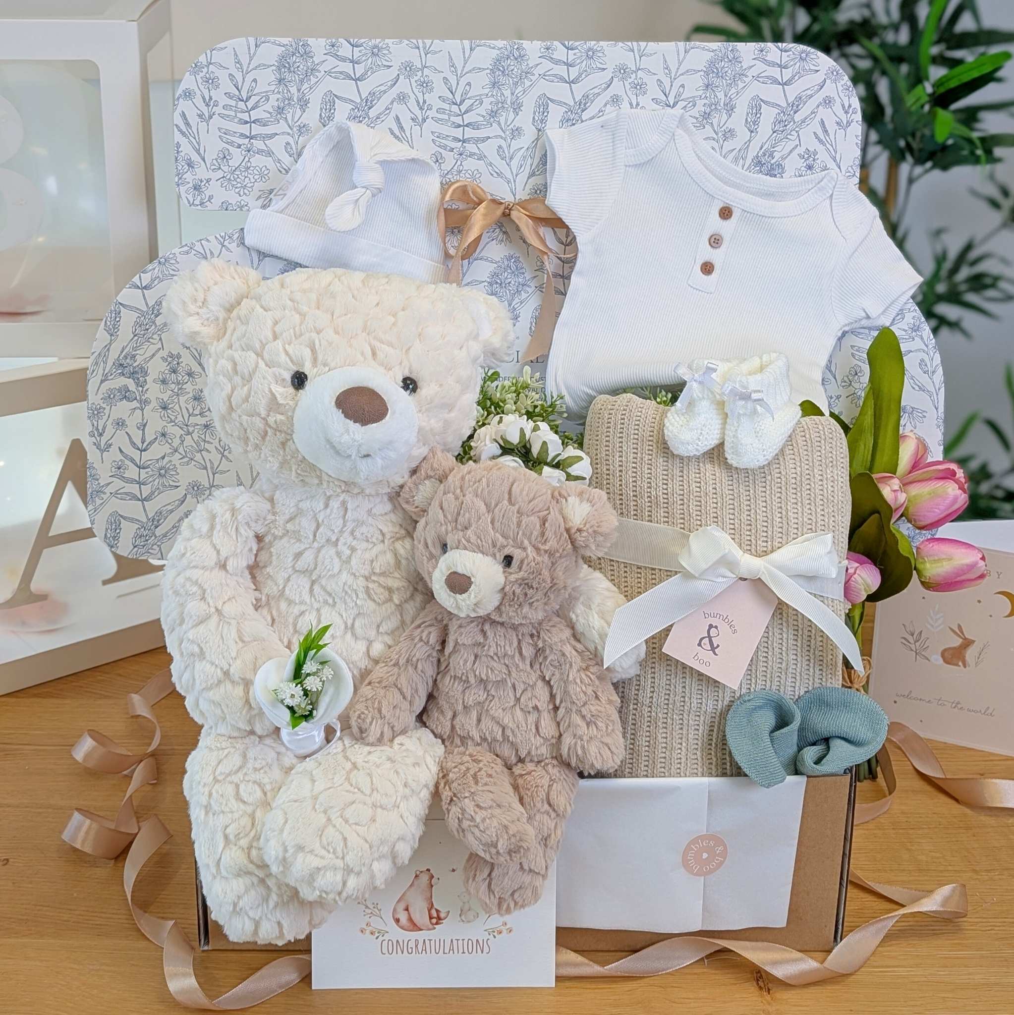 New baby gifts hamper for a newborn and their big brother or sister with big and little teddy bears in a gift box.