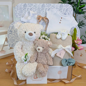 New baby gifts hamper for a newborn and their big brother or sister with big and little teddy bears in a gift box.