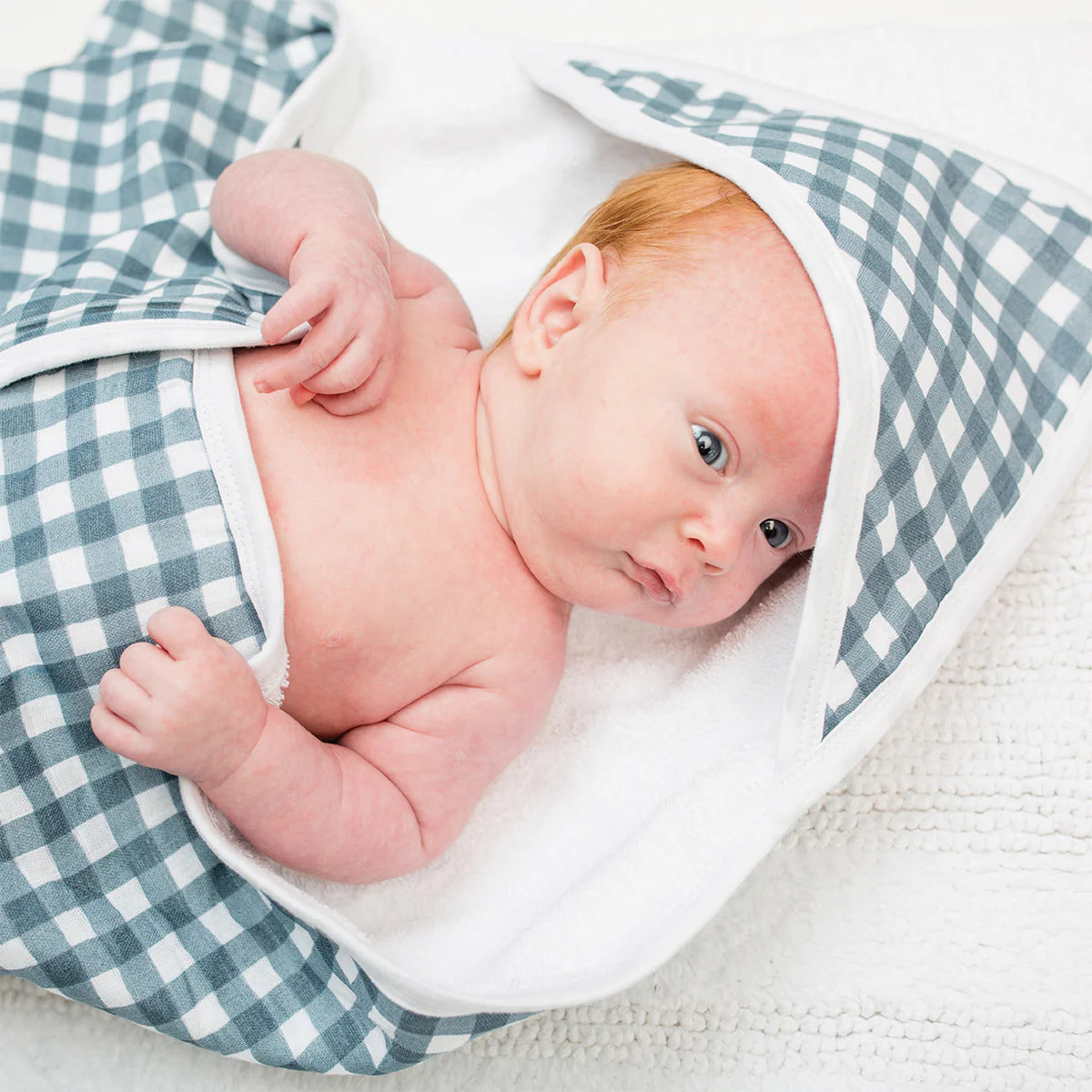 Terry towelling cotton hooded baby towel with a navy gingham design.