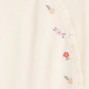 Cream velour baby girl sleepsuit with floral embroidery and frilled side opening