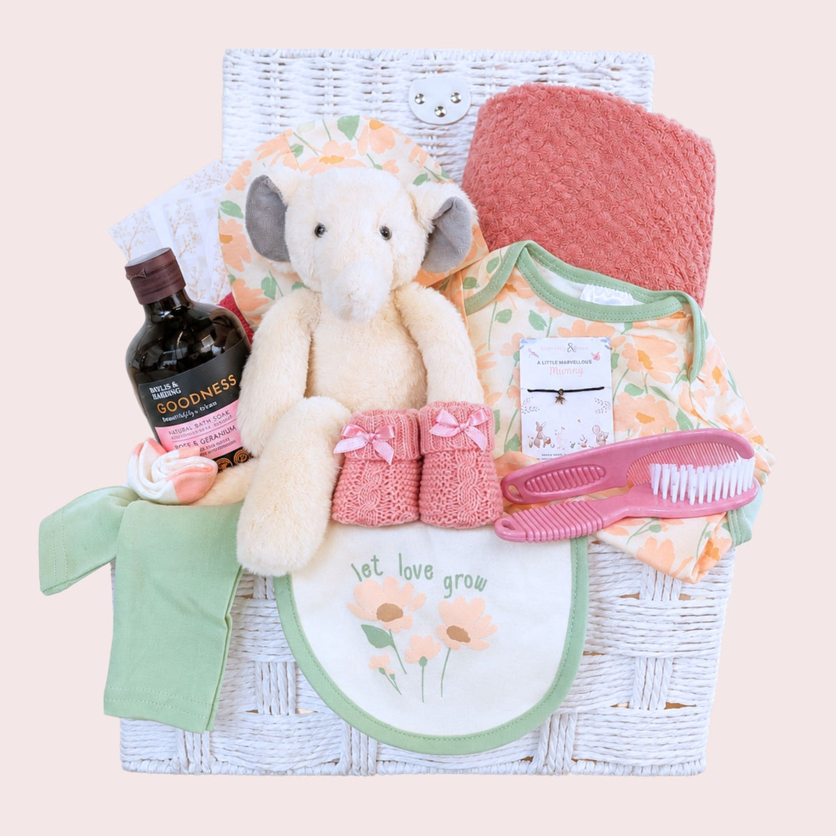New baby girl gifts basket with dusky pink blanket, clothing and elephant soft toy in a hamper by Bumbles and Boo.