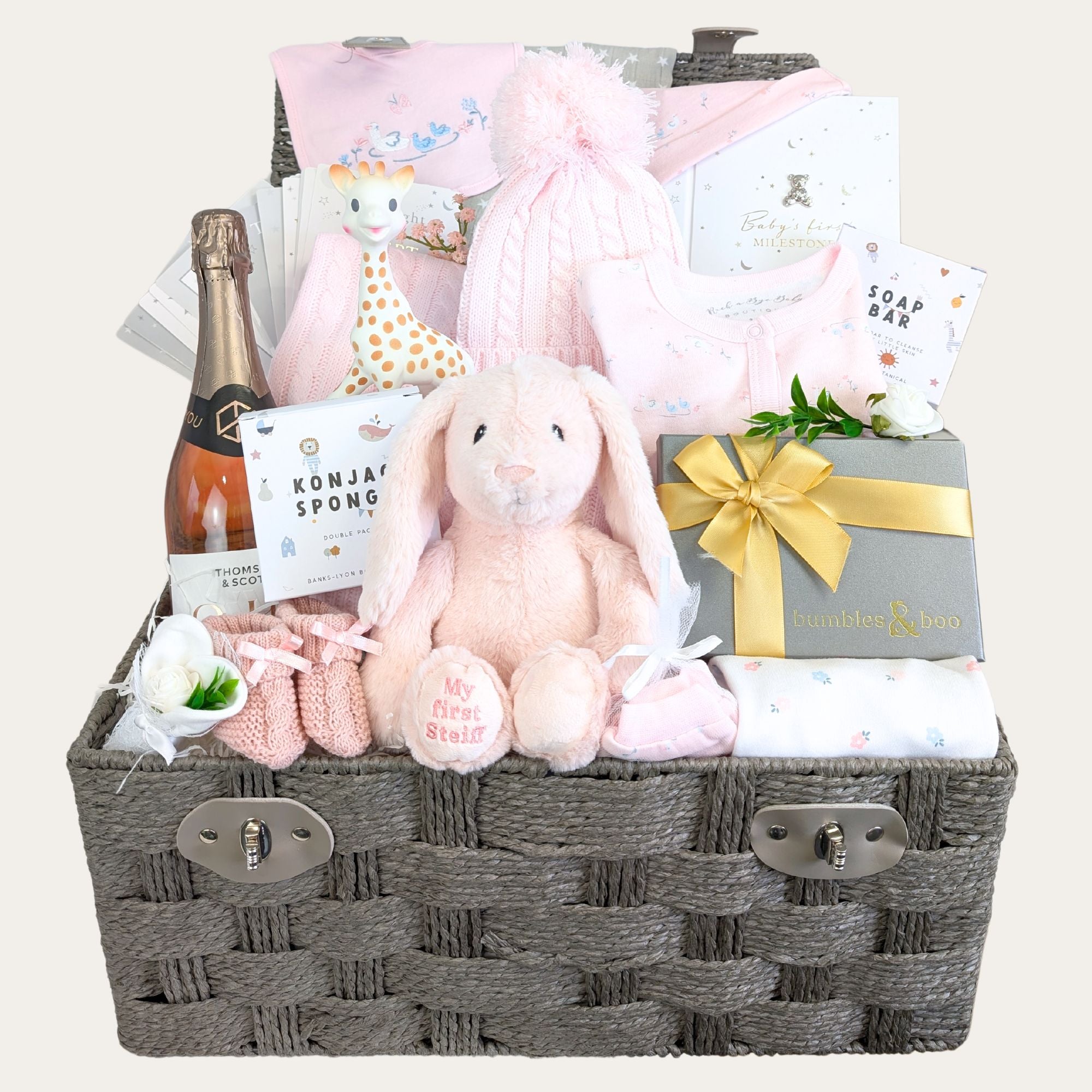 Large baby girl gifts hamper with pink and white presents for mum and baby. Presents in a hamper basket.