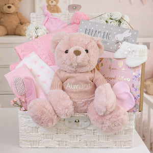 Newborn baby girl gifts basket packed with presents including pink teddy and pink blanket