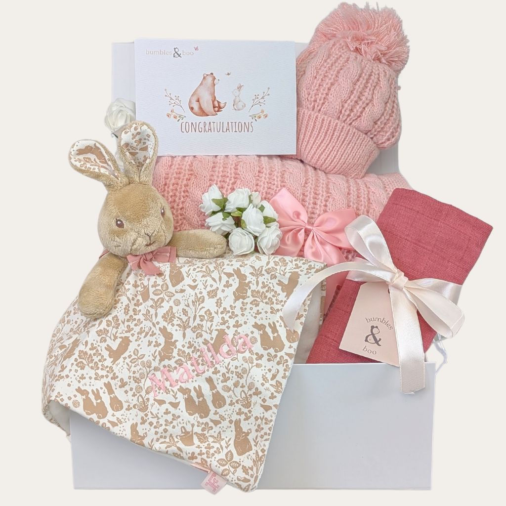 Baby girl gifts packed in a box with pink presents Includes Flopsy Bunny newborn comforter and blanket.