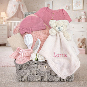 Dusky pink baby girl hamper basket with personalised soft toy and blanket set.